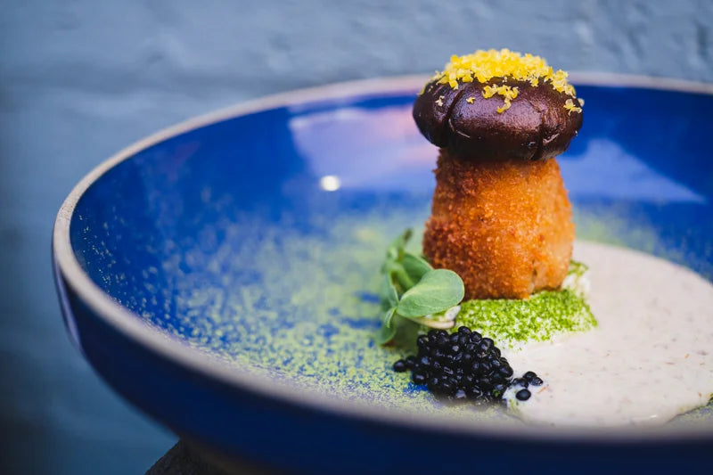A composed dish on a blue plate