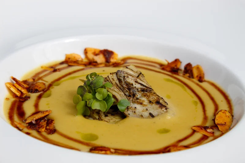 A plated dish with a decorative sauce